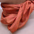 A woman elegantly adorned with a red scarf draped around her neck, exuding style and confidence