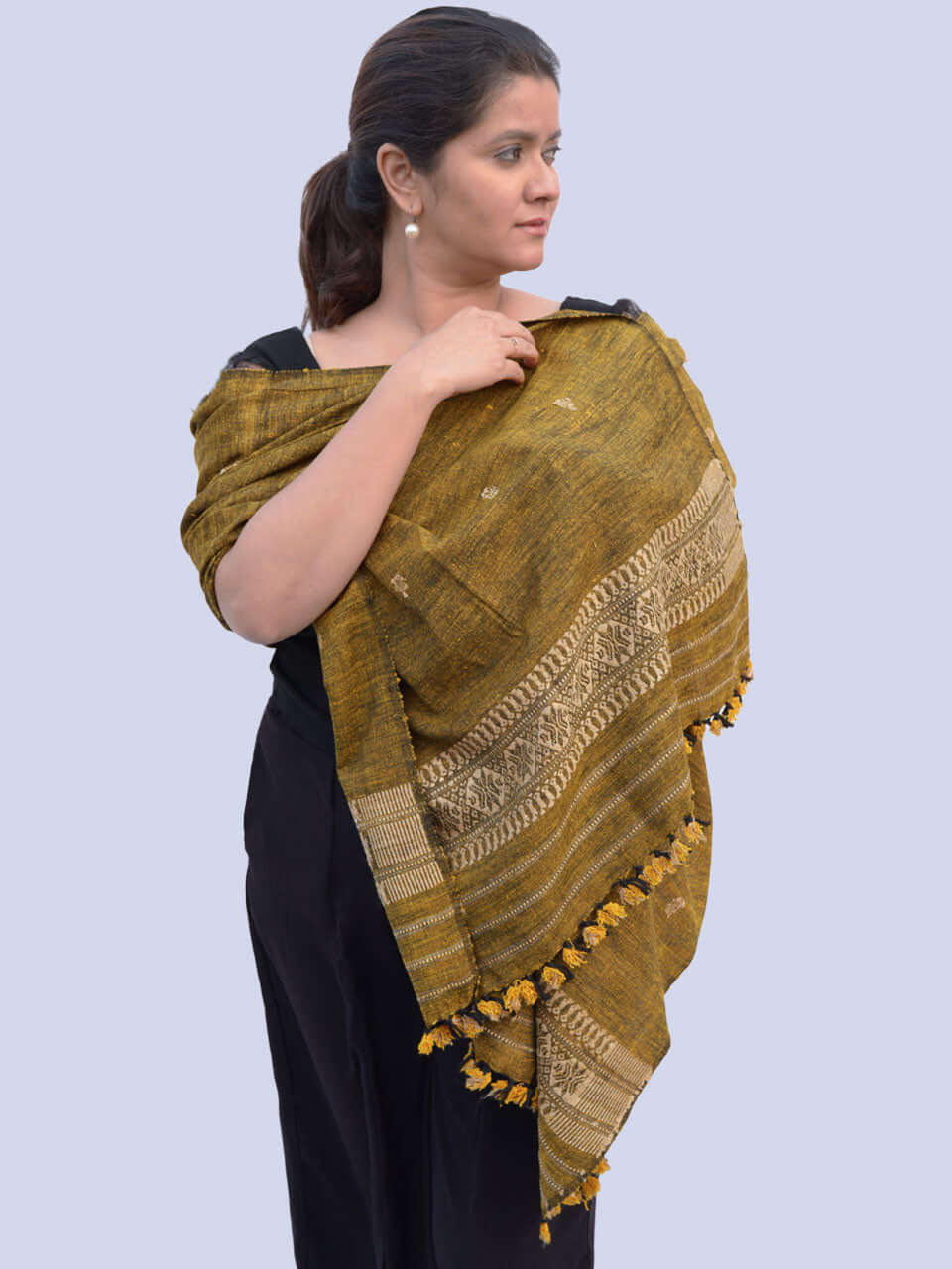 A woman elegantly draped in a mustard-colored scarf, showcasing a warm and stylish accessory