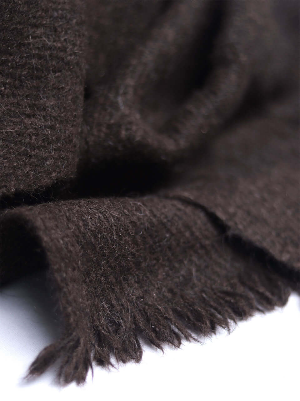 A brown scarf elegantly displayed on a clean white background, highlighting its texture and color contrast