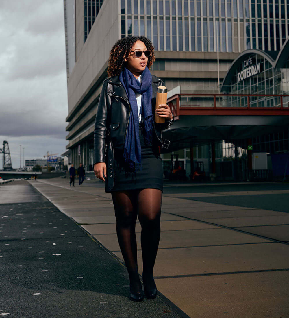 girl wearing stylish sunglasses holding a bottle