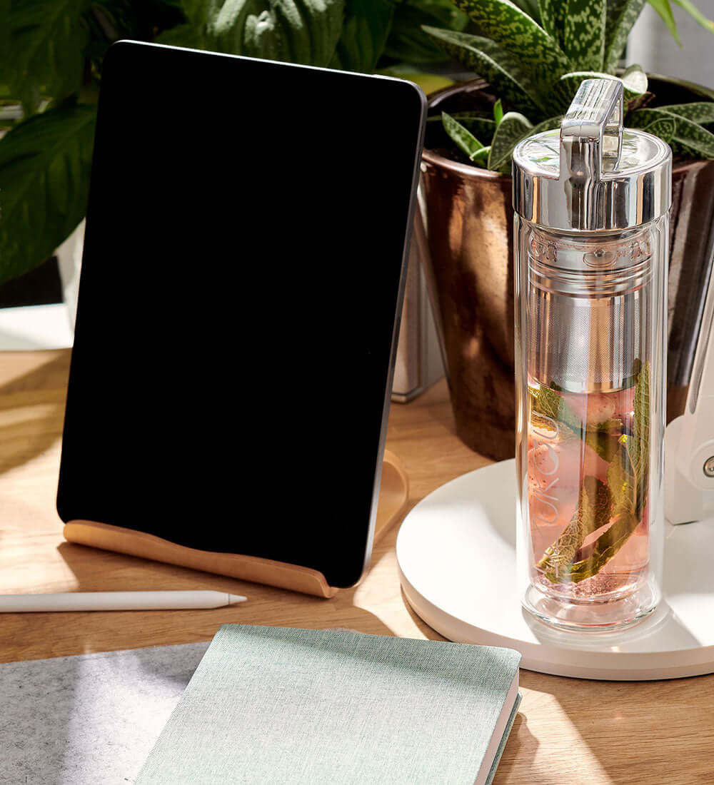 glass tea bottle with a tablet