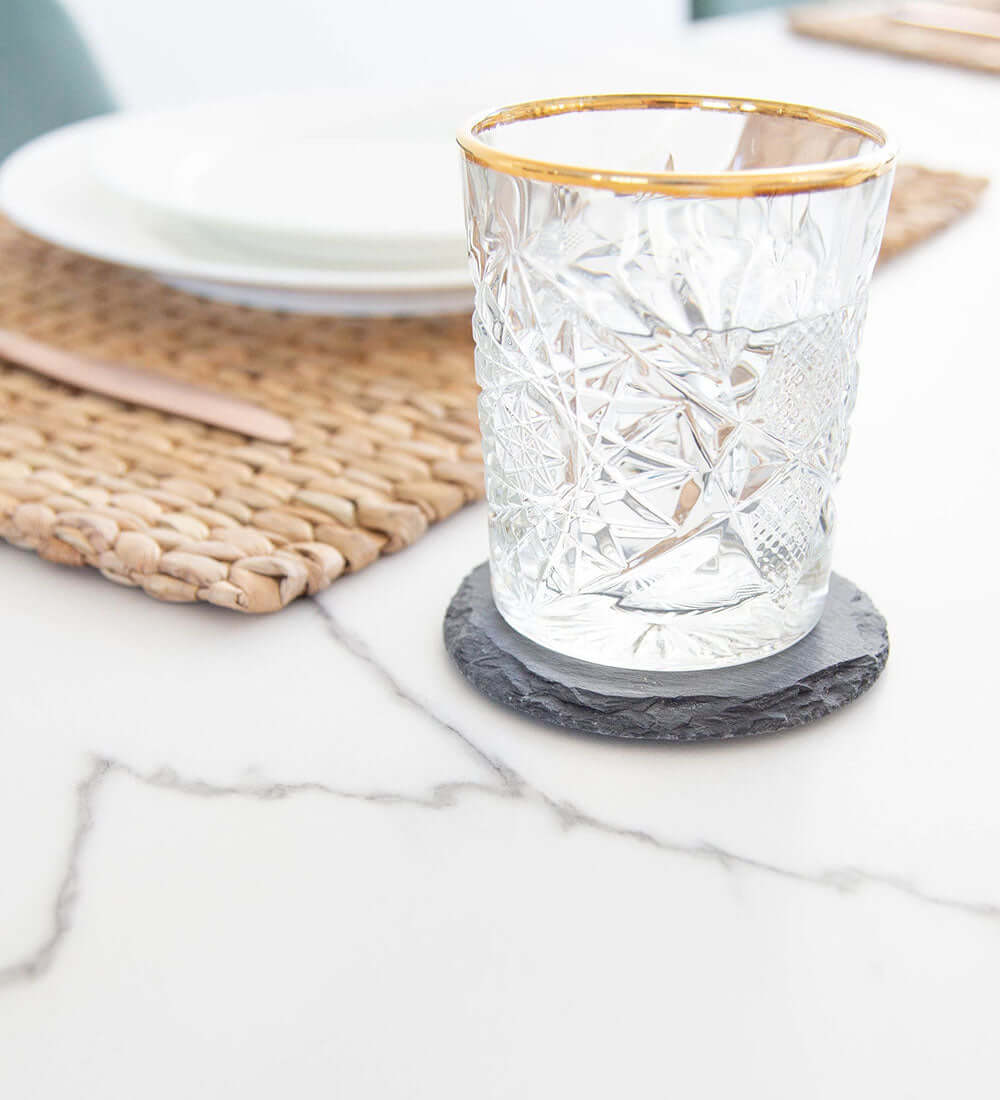 glass kept on a handmade placemat