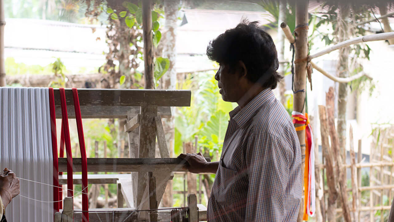Men working on handloom weaving of eri silk