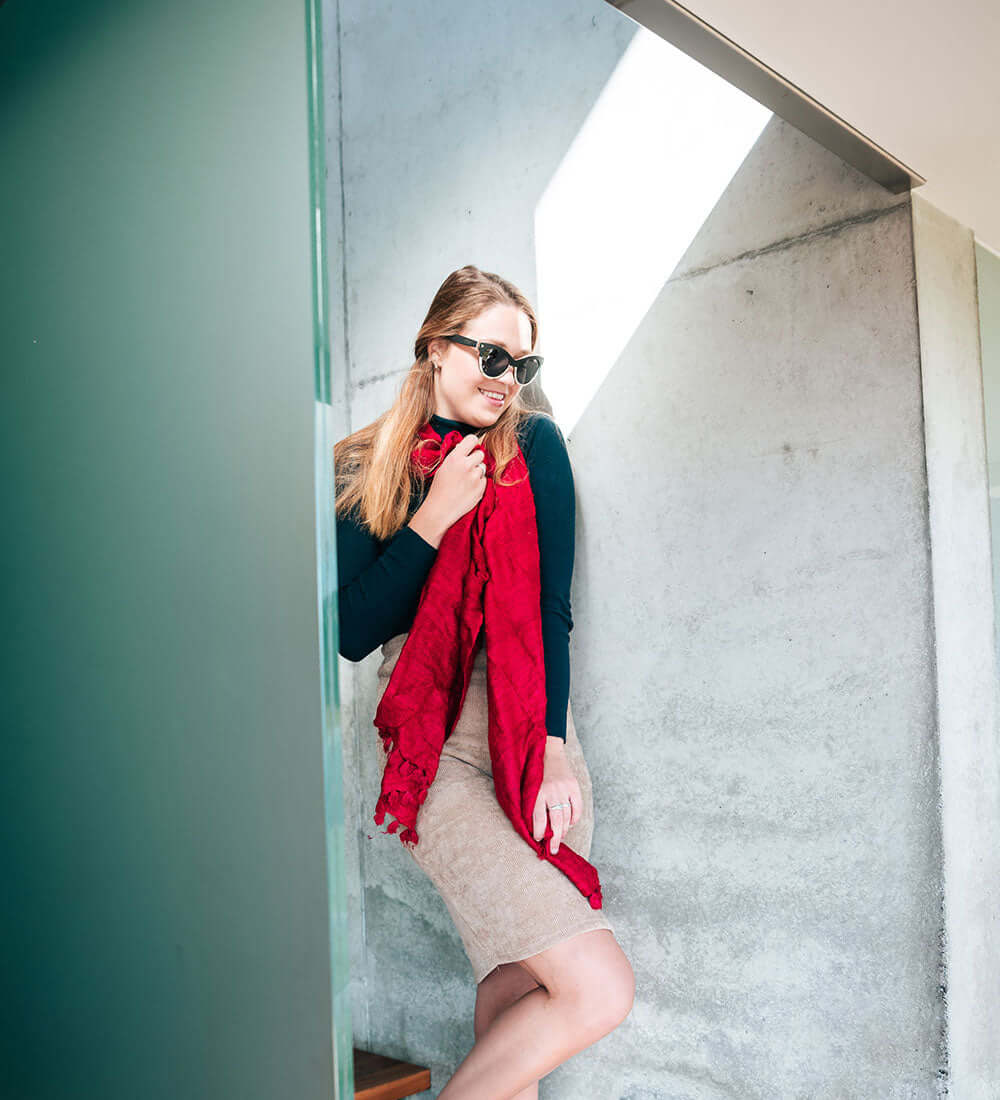 girl wrapped up in a red stole wearing a sunglasses