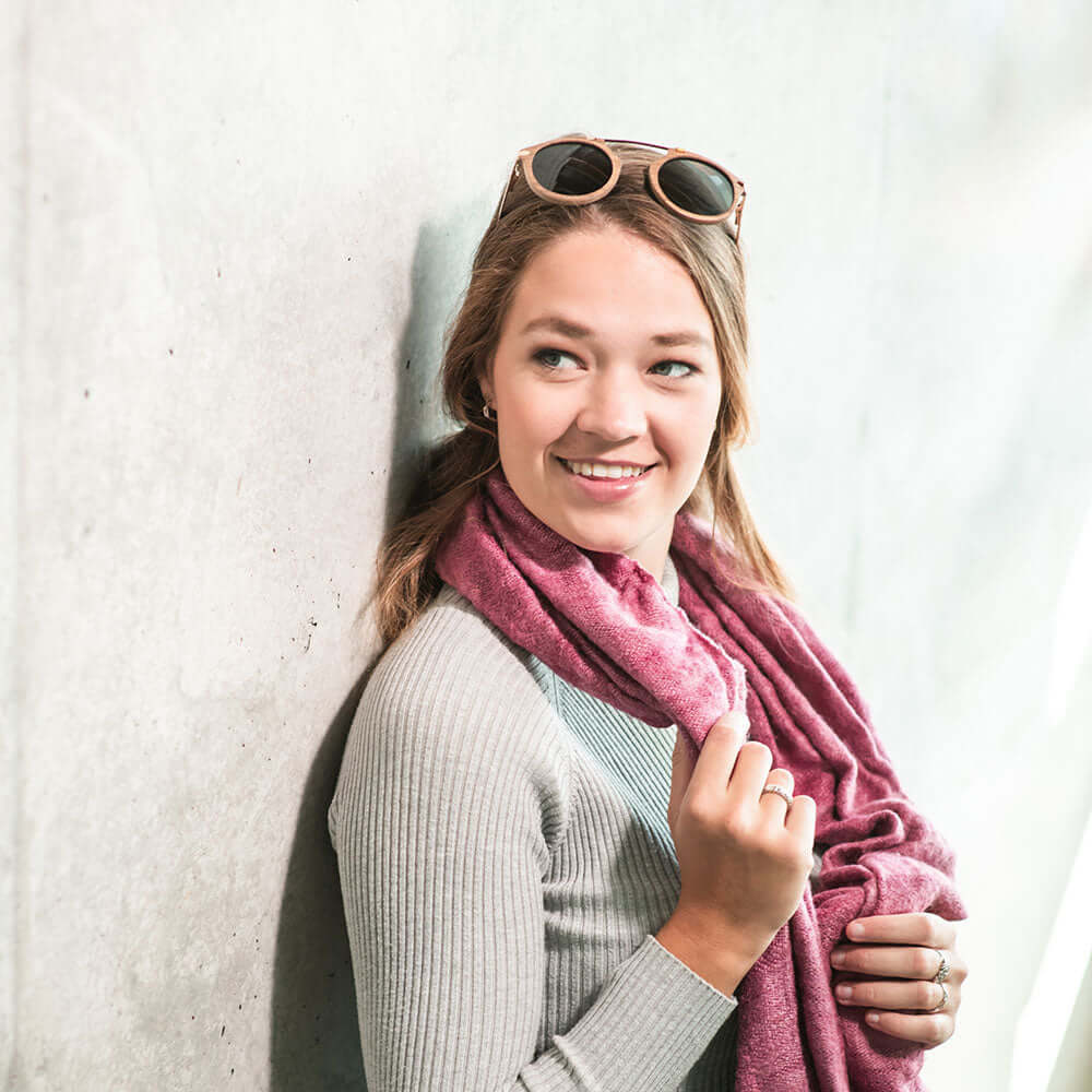 woman wearing a pink stole and sunglasses