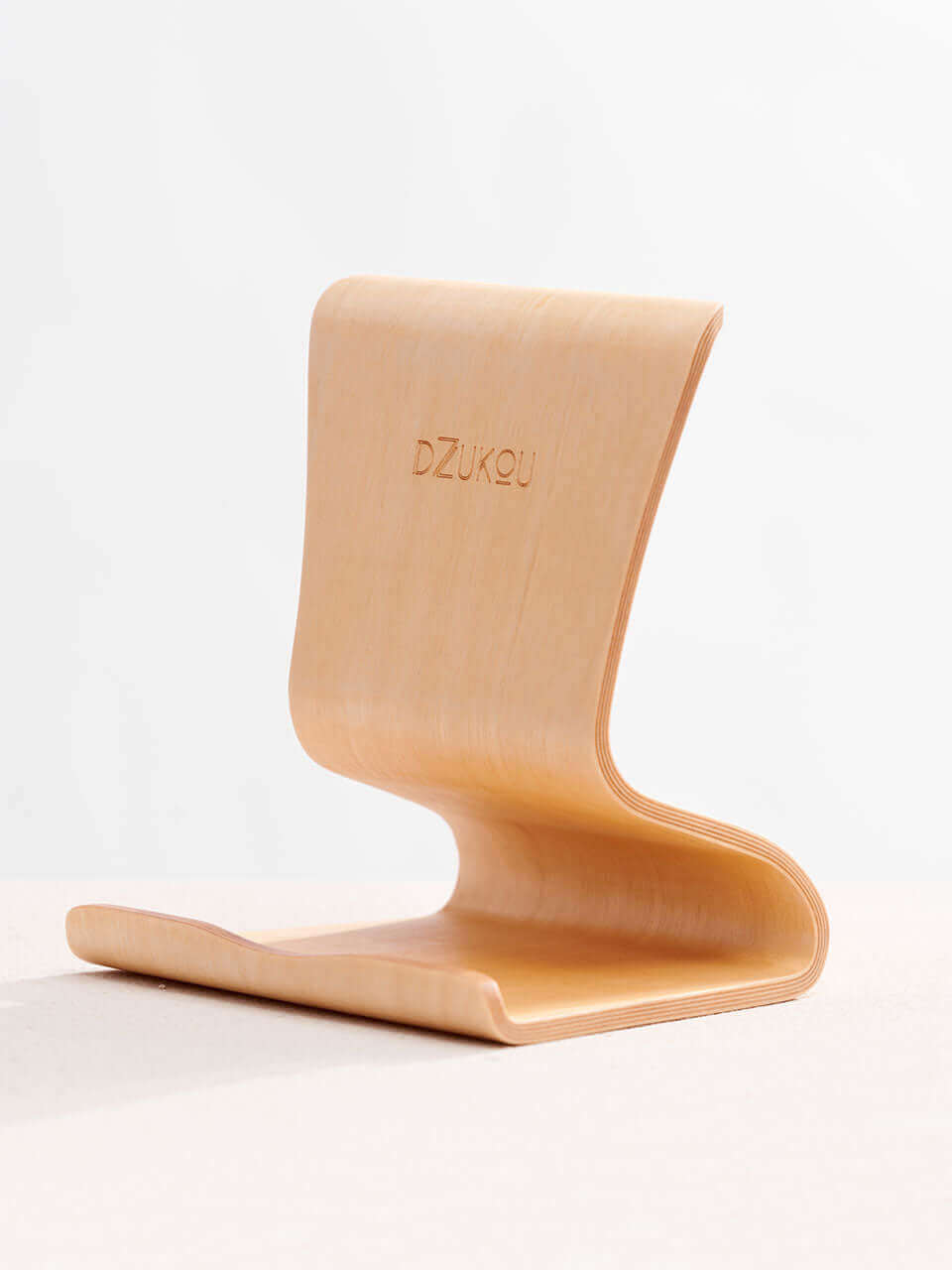 A tablet stand placed on a clean white surface, showcasing a blend of technology and natural materials.