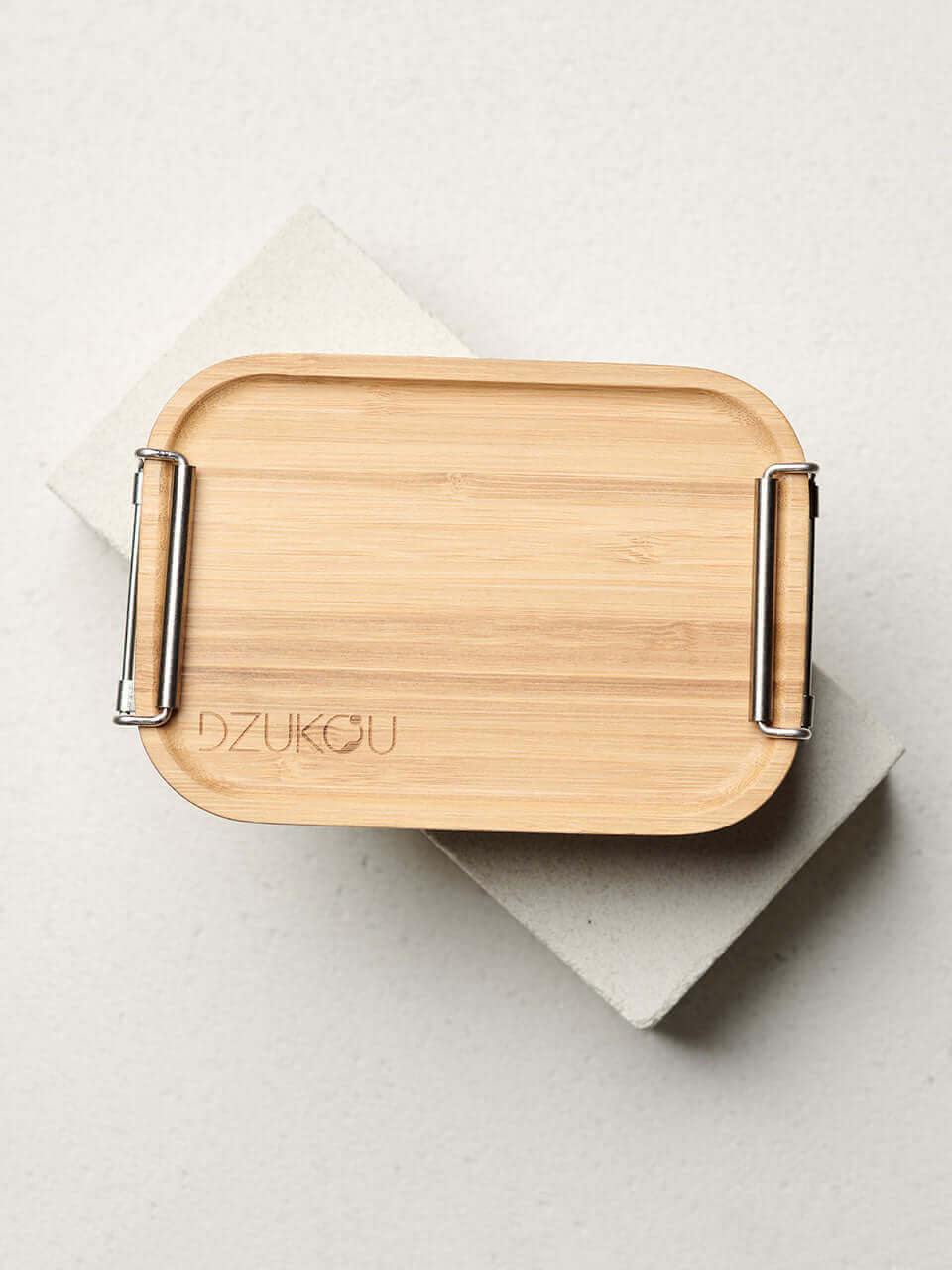 Top view of a bamboo bento box with metal clip, showcasing a sustainable and stylish lunch container.
