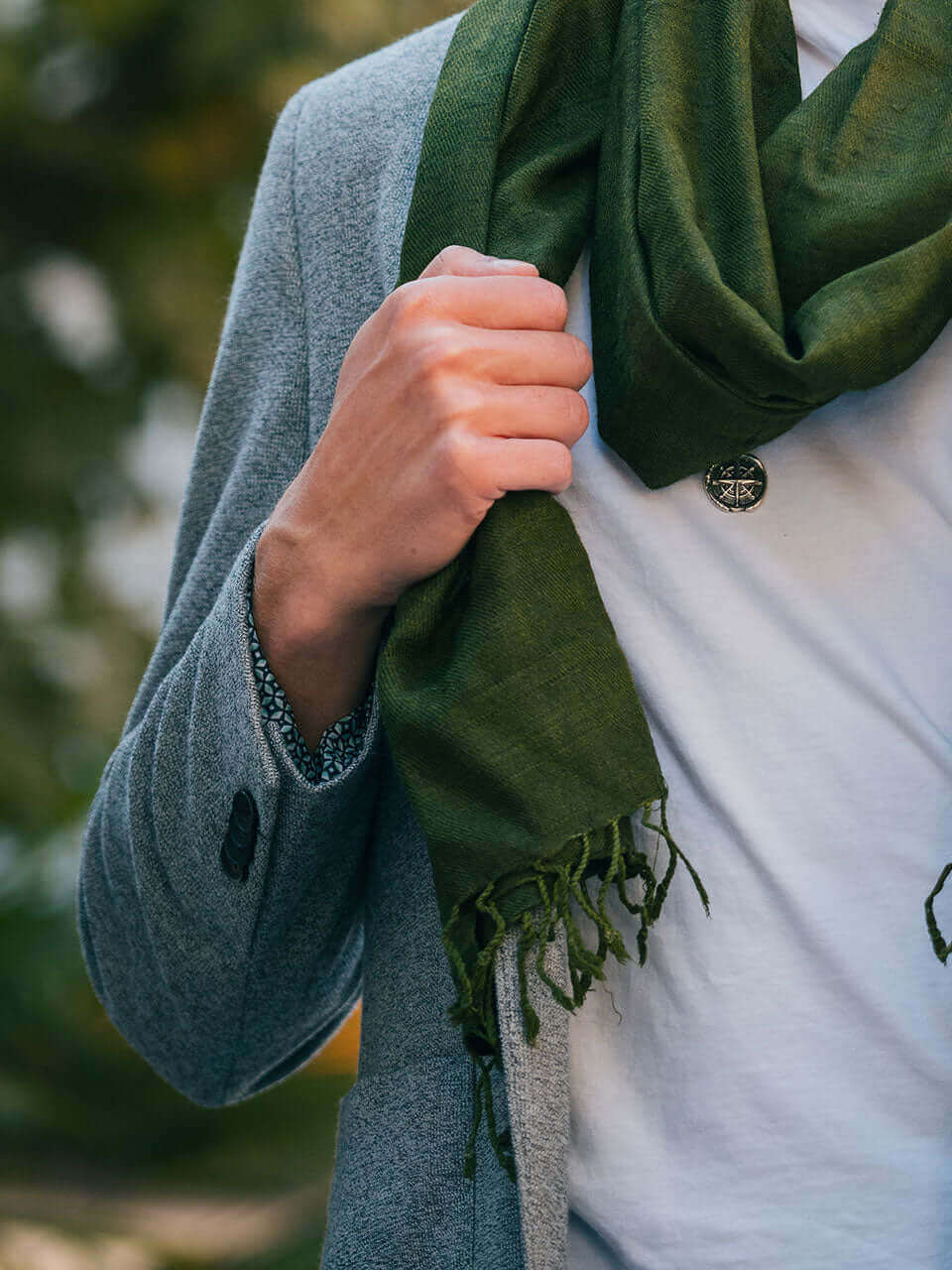 A man wearing a suit and a green scarf, exuding professionalism and style.