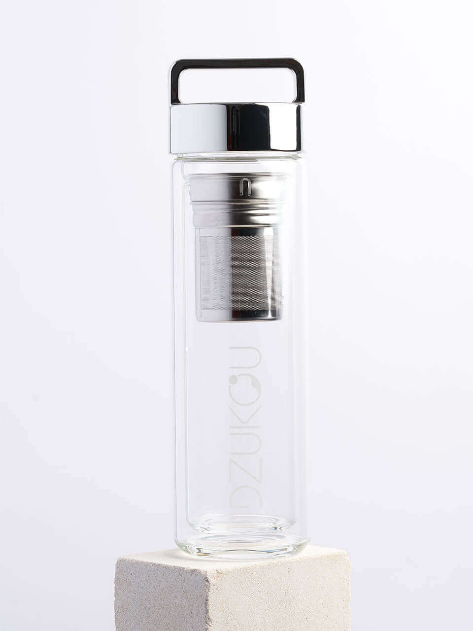 A glass bottle featuring both a silver lid and a metal lid in a white background, showcasing a blend of natural and modern materials.