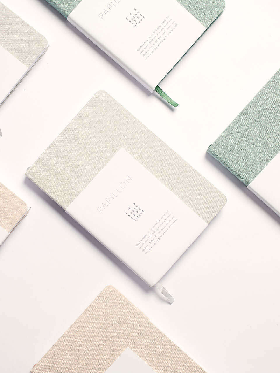 A collection of colorful notebooks featuring various designs arranged neatly on a surface.