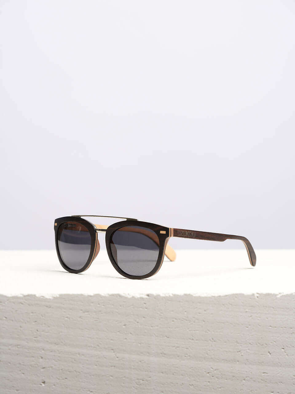 A wooden sunglasses featuring a stylish wooden frame in a clean surface with a neutral background, showcasing a unique and eco-friendly design.