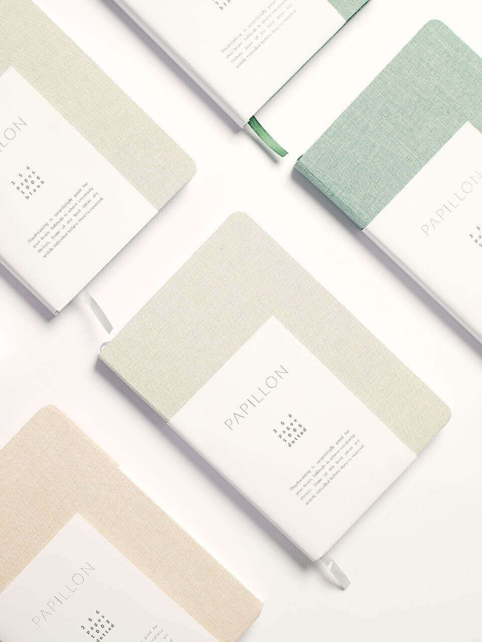 A collection of colorful notebooks featuring various designs arranged neatly on a surface.