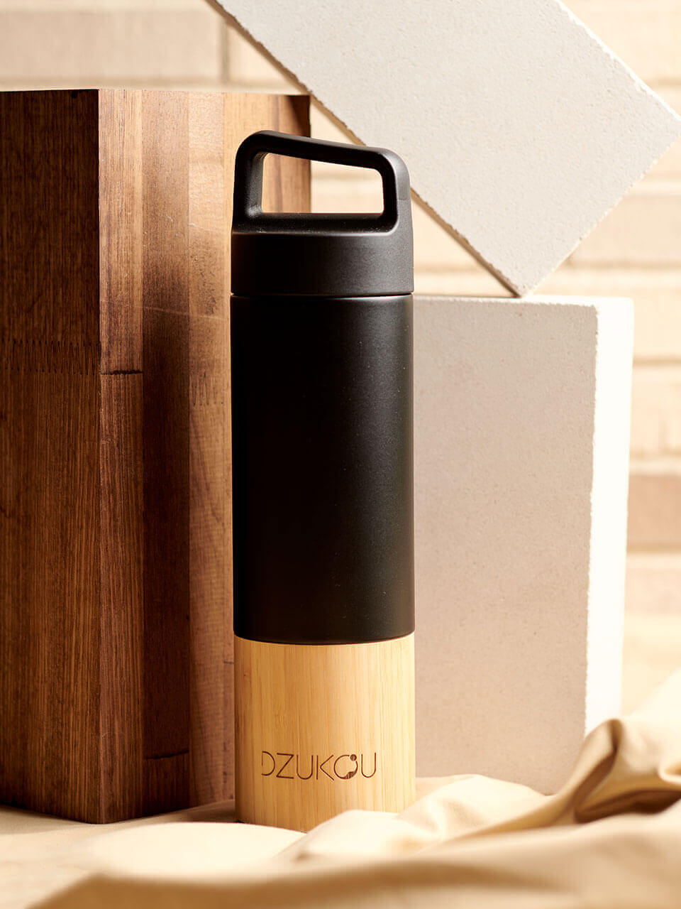 A stainless steel water bottle displayed against a beige background, highlighting its eco-friendly design.