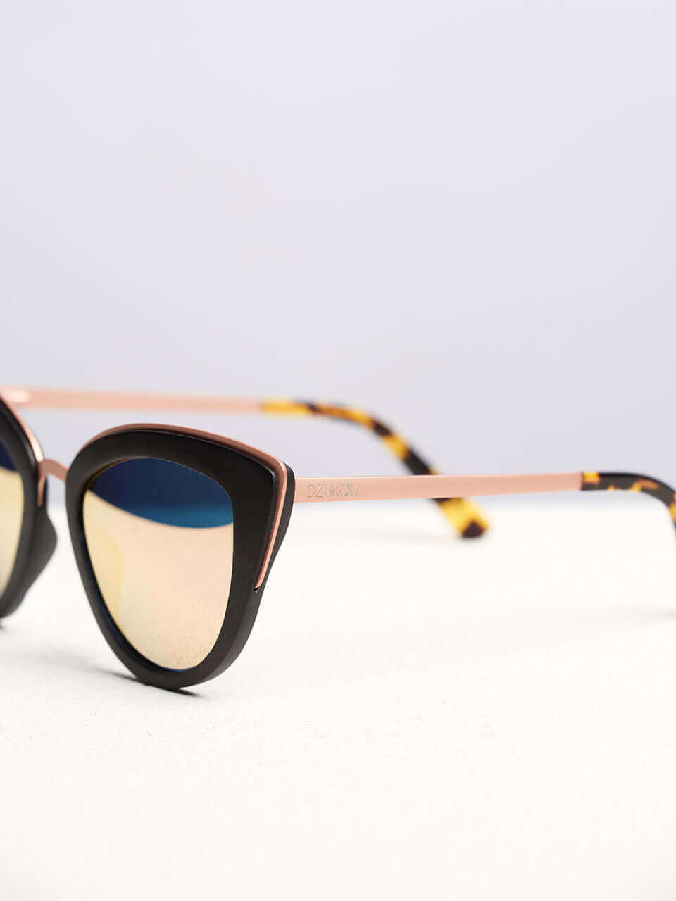 A wooden sunglasses featuring a side view of the stylish wooden frame in a clean surface with a neutral background, showcasing a unique and eco-friendly design.