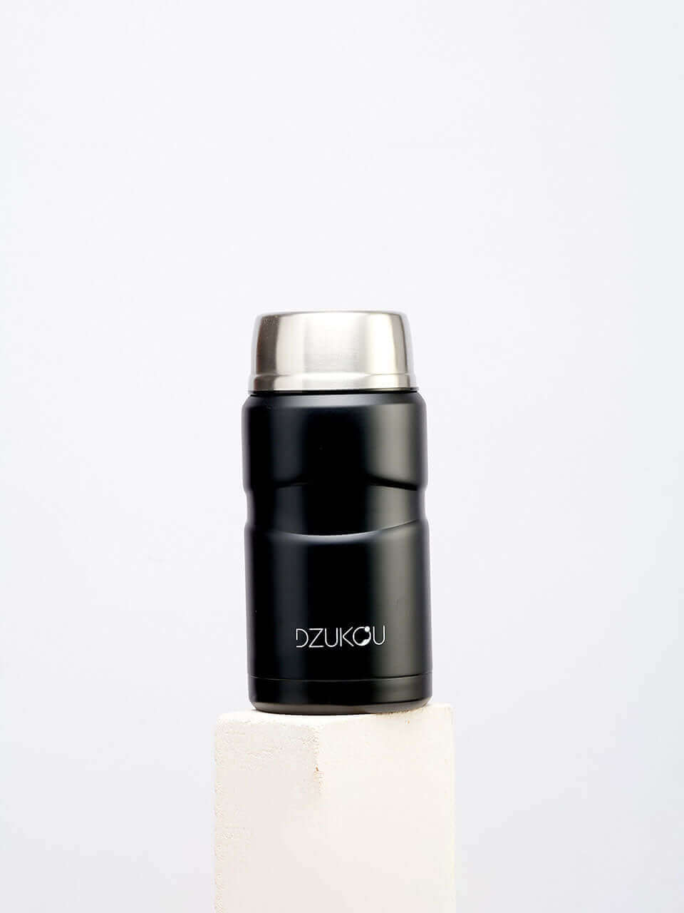 A black thermos lunchpot with a lid, designed for keeping beverages hot or cold, placed on a neutral background.