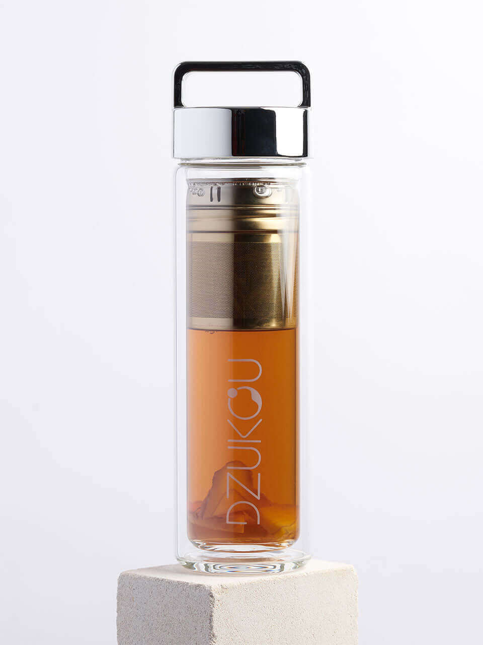 A glass bottle featuring both a silver lid and a metal lid in a white background, showcasing a blend of natural and modern materials.
