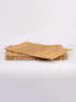 A stack of four water hyacinth placemats pieces arranged neatly on a white background, showcasing their natural texture and color.