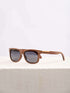 A wooden sunglasses featuring a stylish wooden frame in a clean surface with a neutral background, showcasing a unique and eco-friendly design.