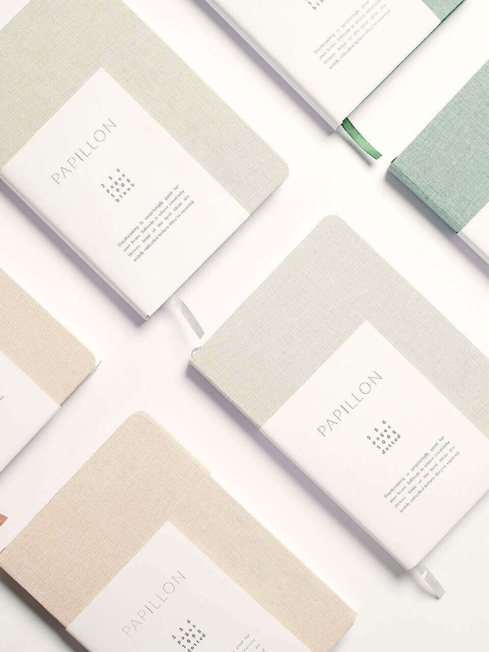 A collection of colorful notebooks featuring various designs arranged neatly on a surface.