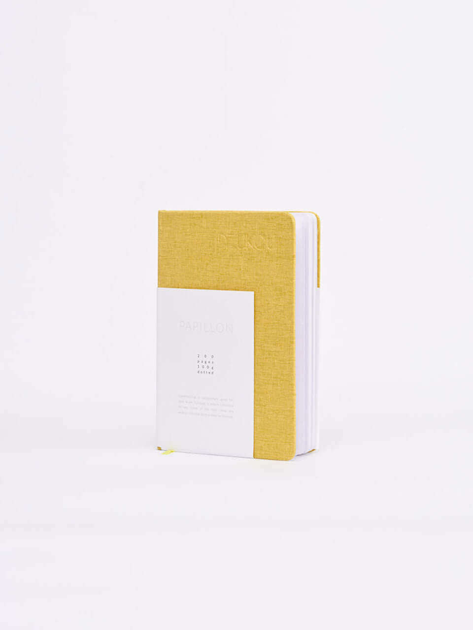A linen notebook place beside a white block with a clean white background.