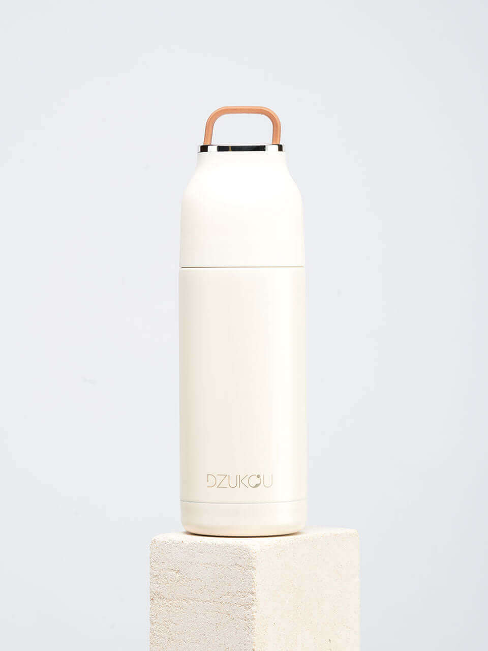 A white water bottle featuring a handle, showcasing a blend of modern and natural design elements.