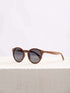 A wooden sunglasses featuring a stylish wooden frame in a clean surface with a neutral background, showcasing a unique and eco-friendly design.