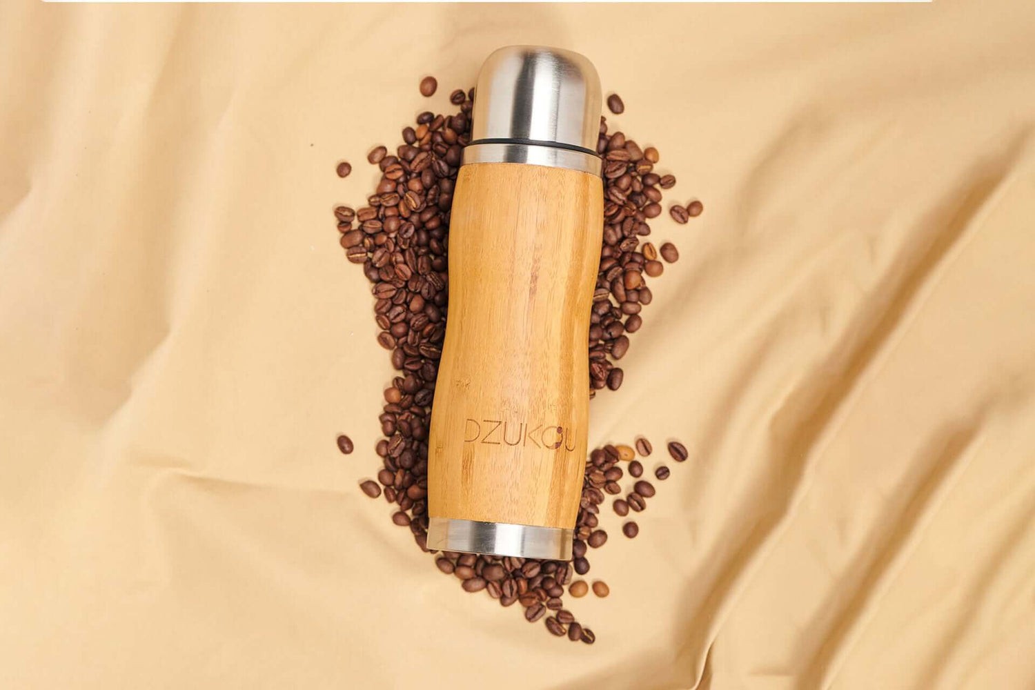 bottle with coffee beans around it