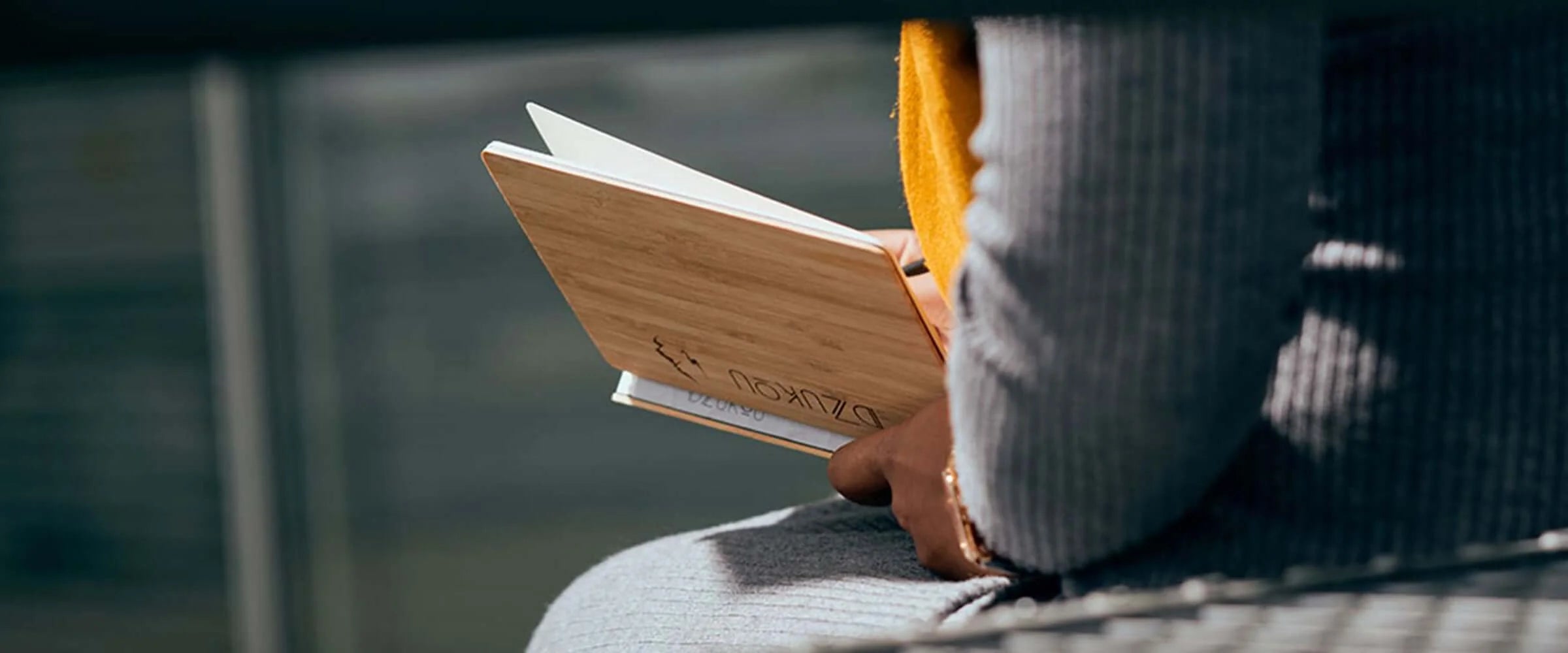 Girl writing in bamboo notebook