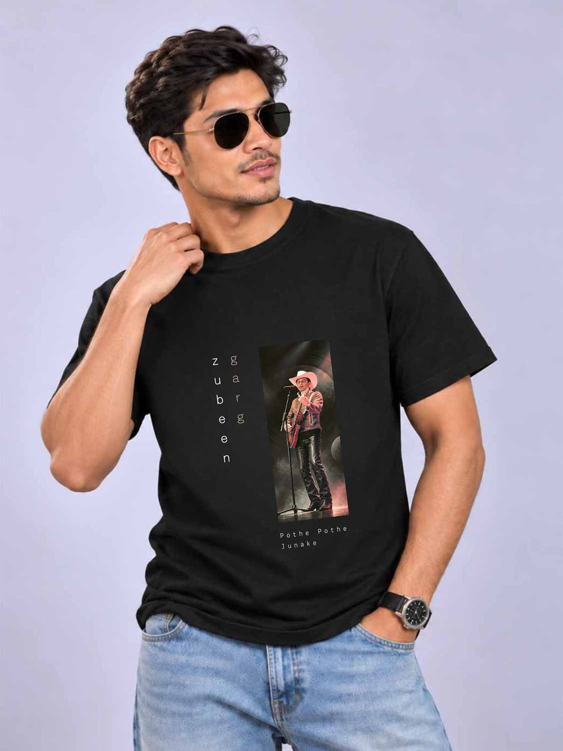 A man wearing a black short-sleeve graphic t-shirt with a vertical print of Paulina Rubio and the text &