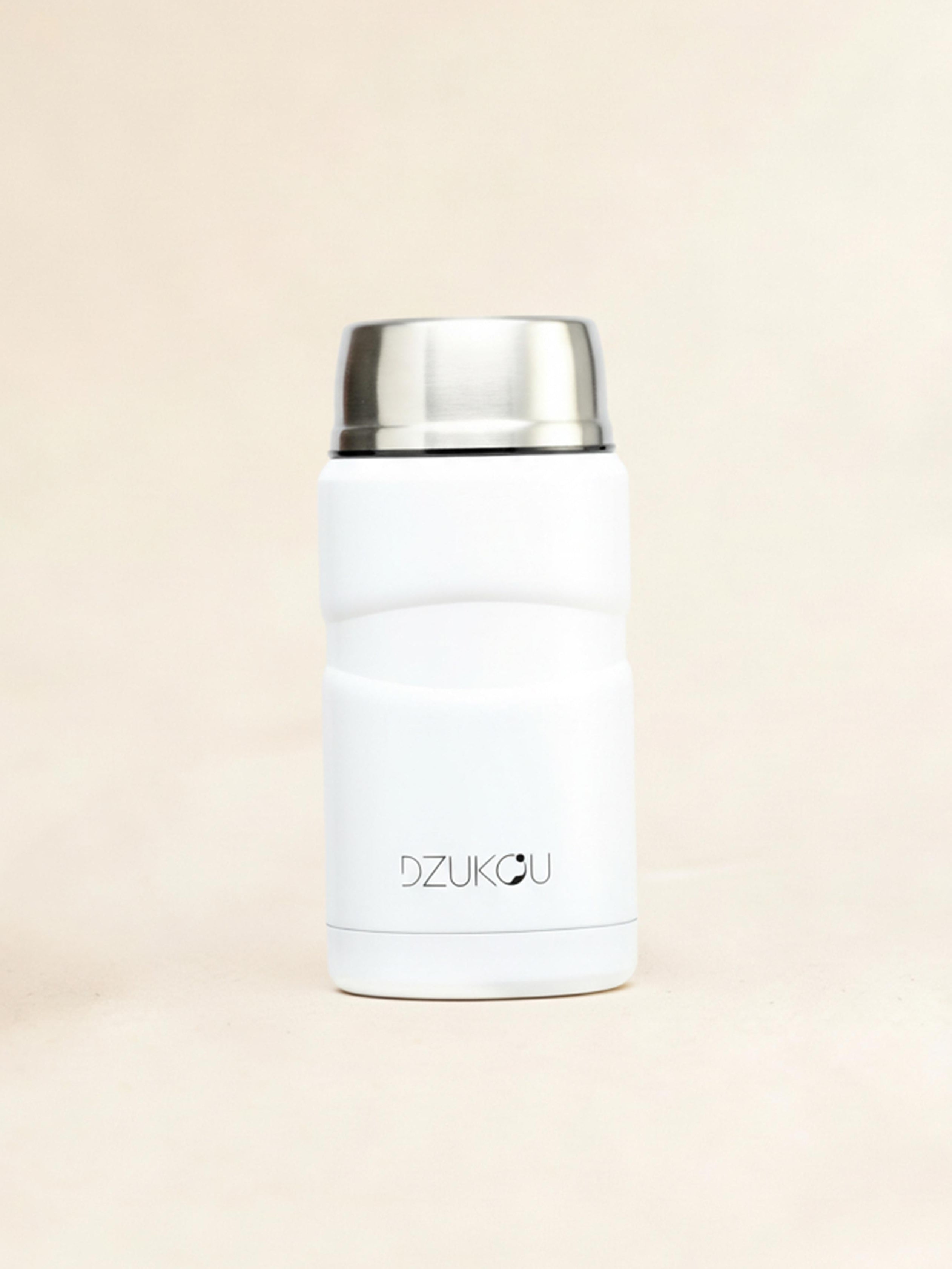 White thermos with silver lid on a beige background
