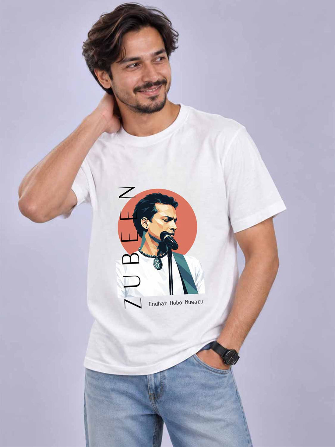 A man wearing a white graphic t-shirt featuring a stylized portrait of Hibo Nawaz and the text &