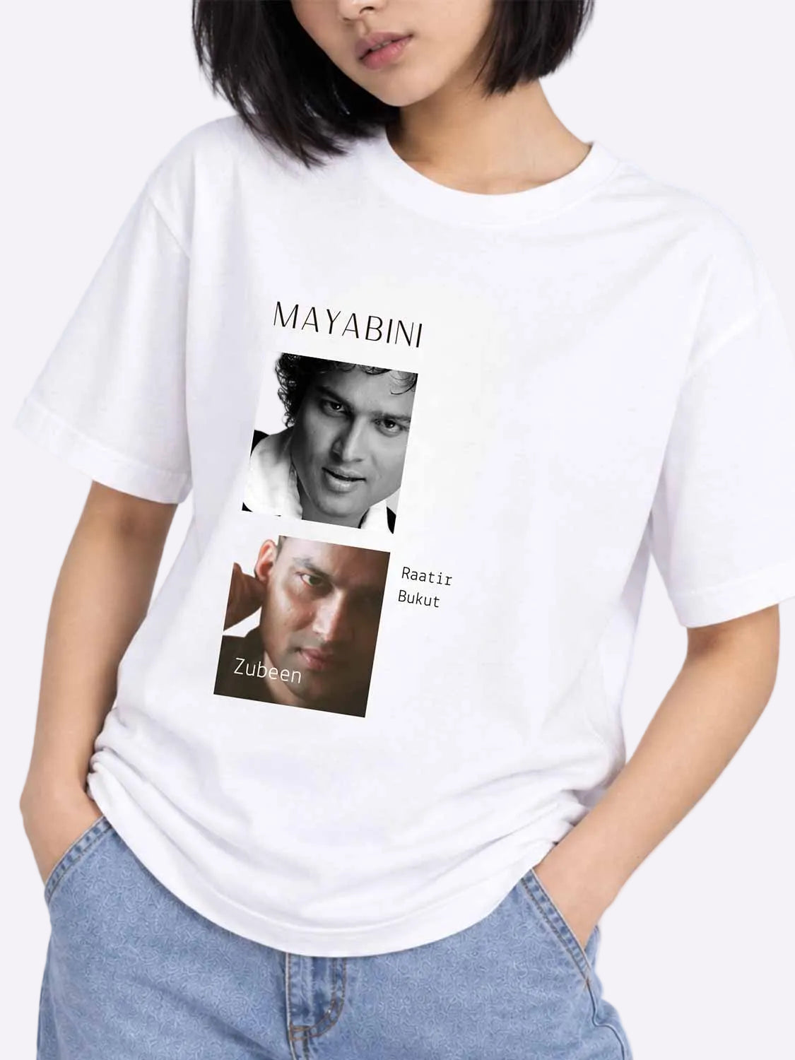 A white short-sleeve graphic T-shirt worn by a model, featuring a black-and-white portrait of Mayabini with the text &