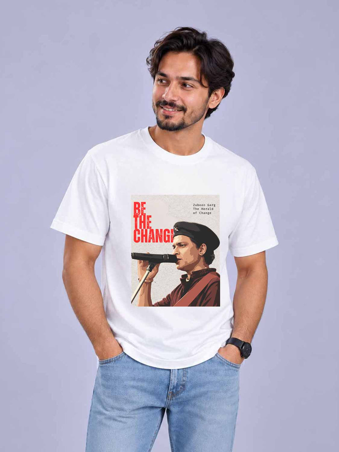 A man wearing a white graphic t-shirt with a vintage-style print of a man holding a gun and the text &