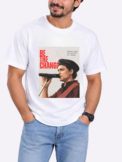 A man wearing a white graphic t-shirt with a vintage-style print of a man holding a gun and the text &