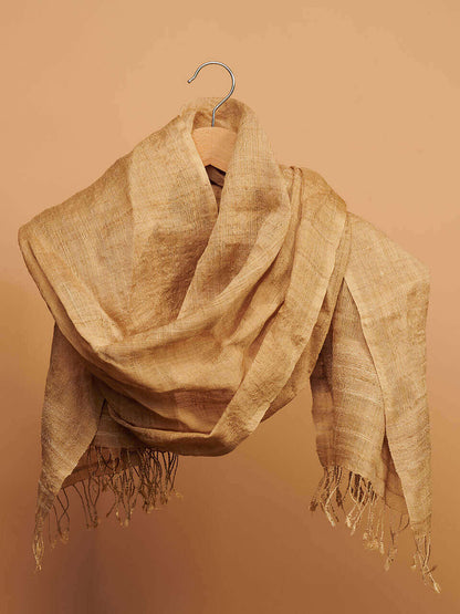 A muga scarf elegantly draped over a hanger, showcasing its soft texture and neutral color