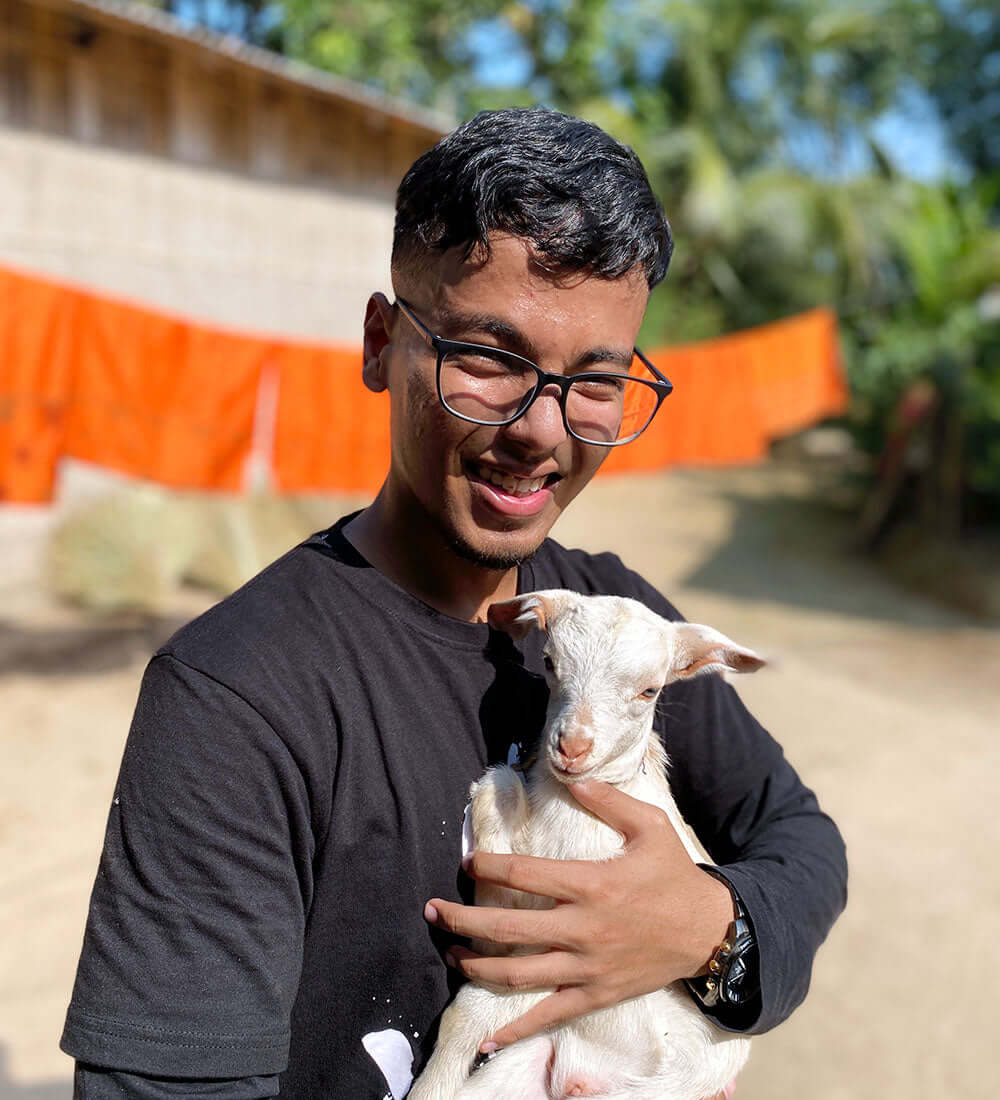 boy holding a goat