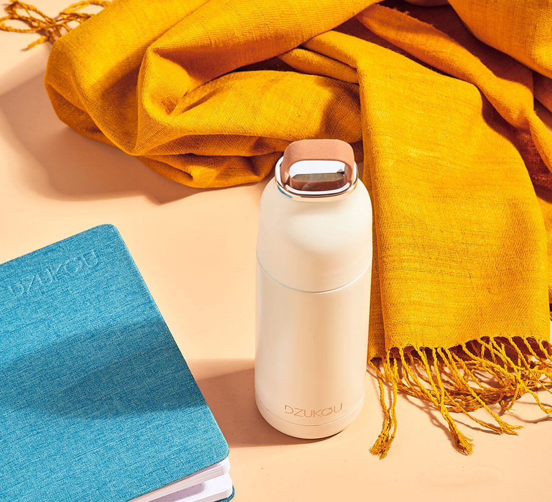 a blue notebook with a water bottle