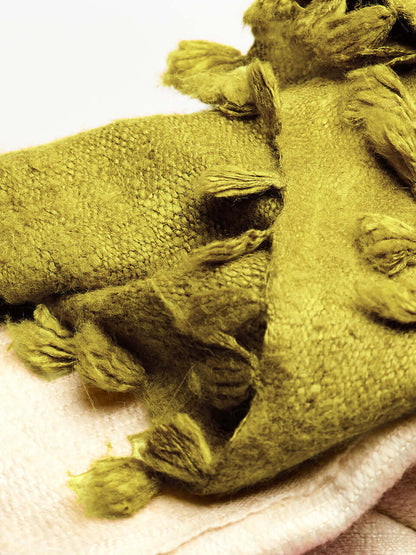 An olive Eri silk shawl spread out on a surface, highlighting its soft texture and natural color.