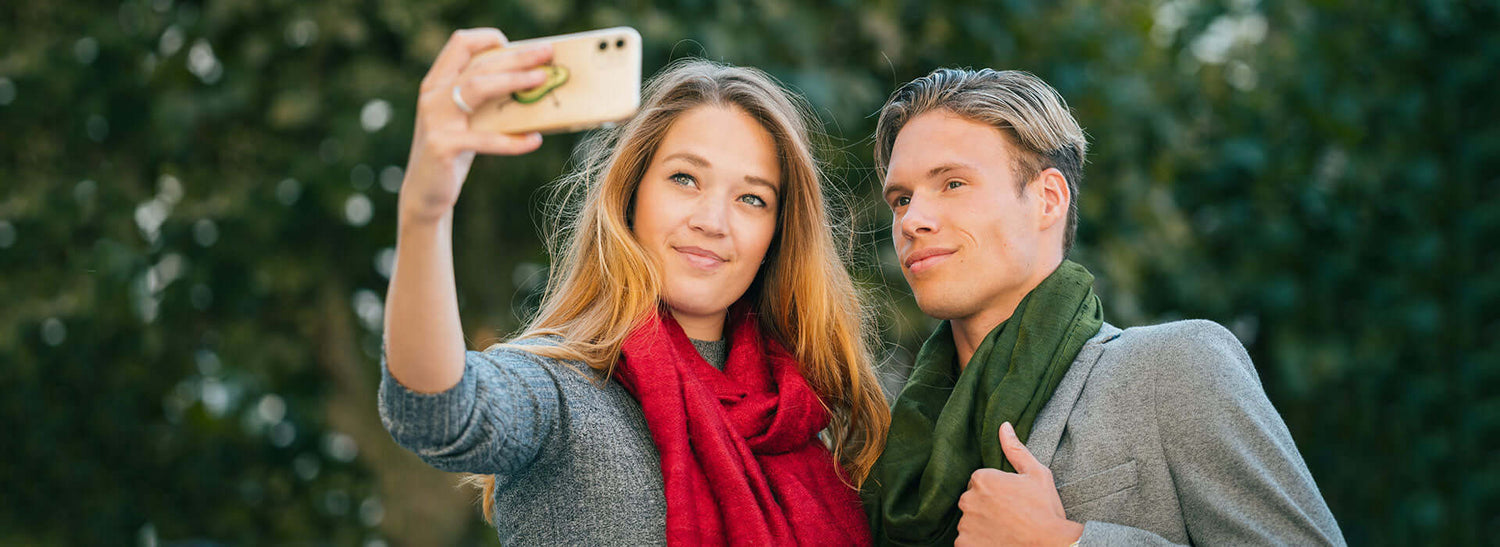 two people wearing stoles clicking selfies