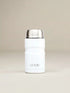 White insulated bottle with silver lid on a beige background