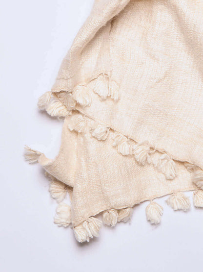 A white Eri silk shawl spread out on a surface, highlighting its soft texture and natural color.