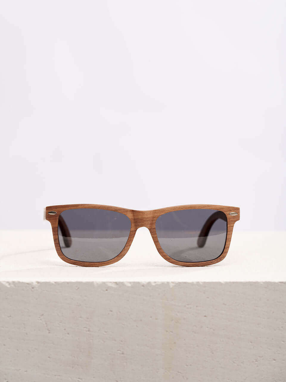 wooden sunglasses kept on a white platform