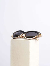 cat eye wooden sunglasses kept on a white platform