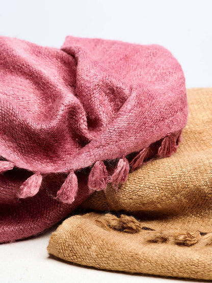 A pink Eri silk shawl spread out on a surface, highlighting its soft texture and natural color.