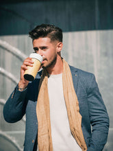 Man drinking from coffee tumbler
