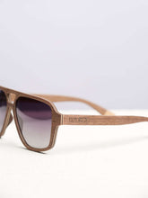 side view of wooden sunglasses on white platform
