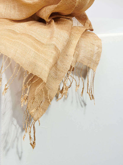 A muga scarf elegantly displayed on a white pedestal against a rich white background