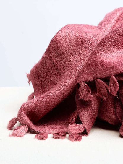 A pink Eri silk shawl spread out on a surface, highlighting its soft texture and natural color.