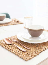 Cup and saucer kept on Placemats