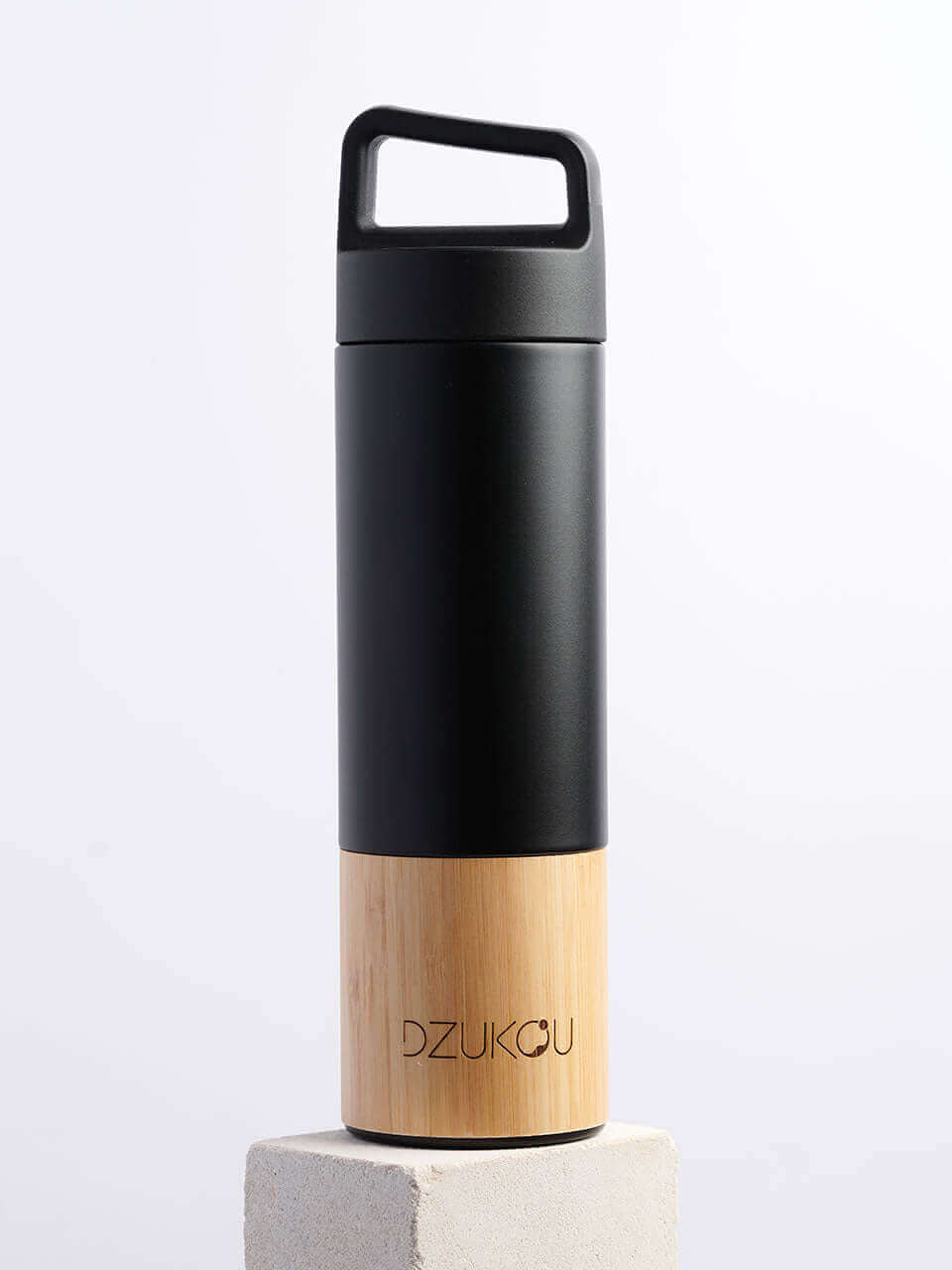 A black and bamboo water bottle featuring a handle, showcasing a blend of modern and natural design elements.